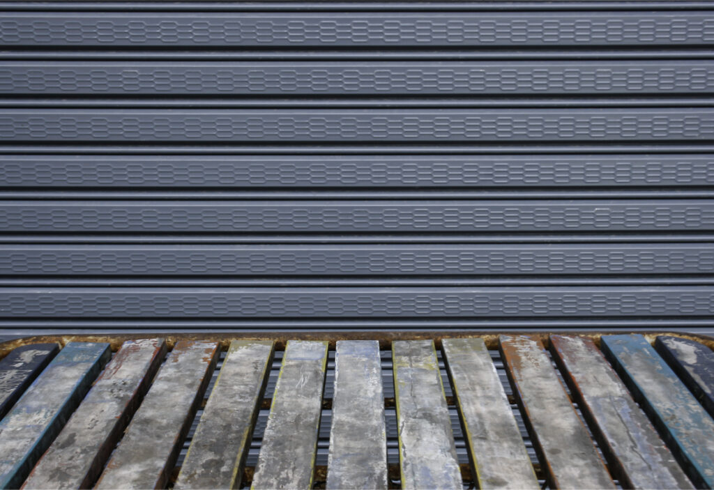 old wooden table in front of the steel shutter door